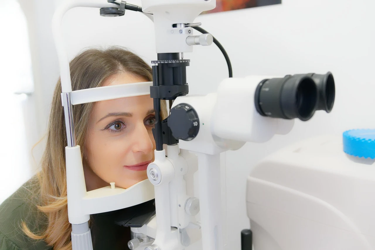 Woman rests her chin on a slit lamp during an eye exam at an ophthalmologist's, a routine glaucoma check