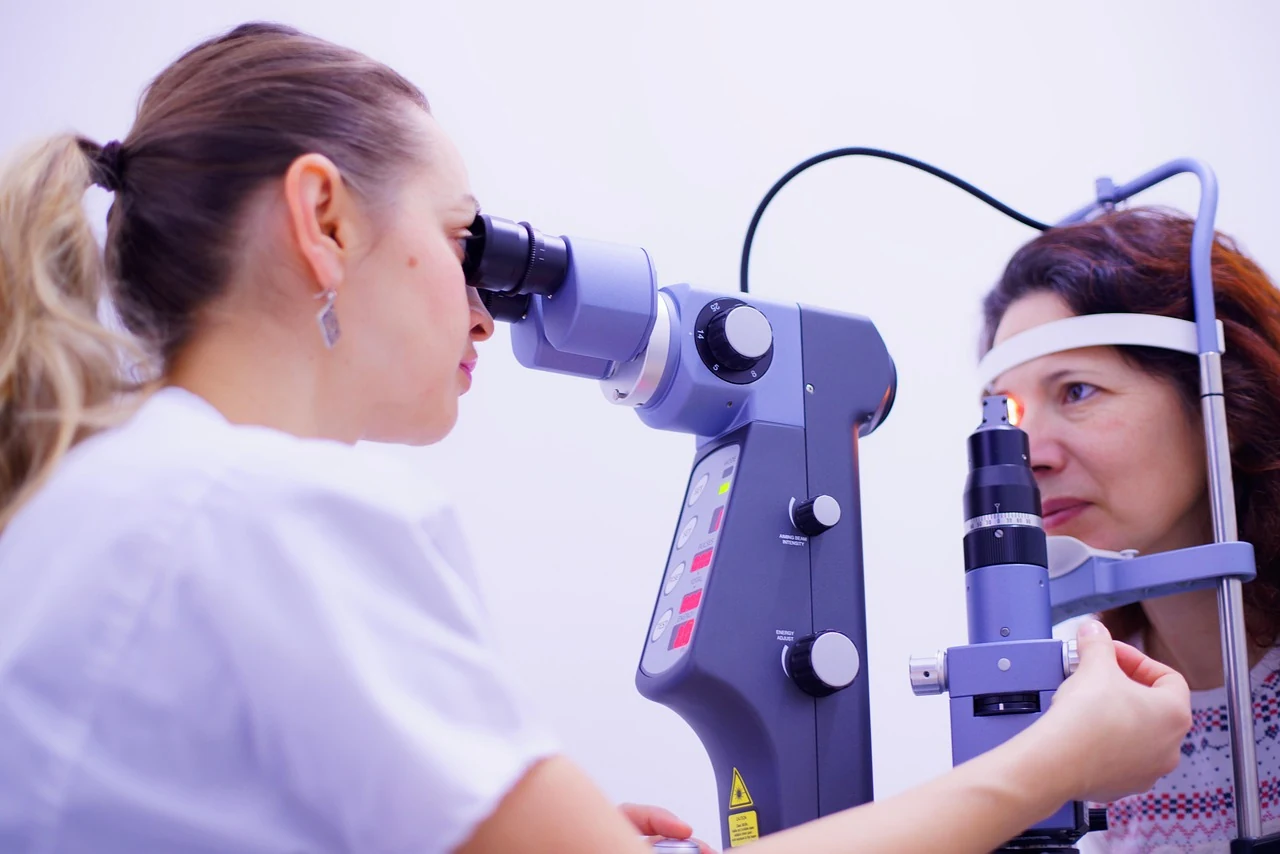 Ophthalmologist looks through a slit lamp to check a patient's eyes during a routine eye exam