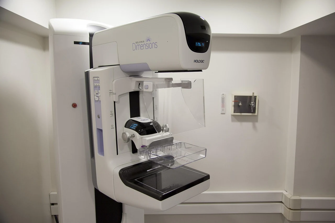 White mammography machine in a screening room, used to catch breast cancer early