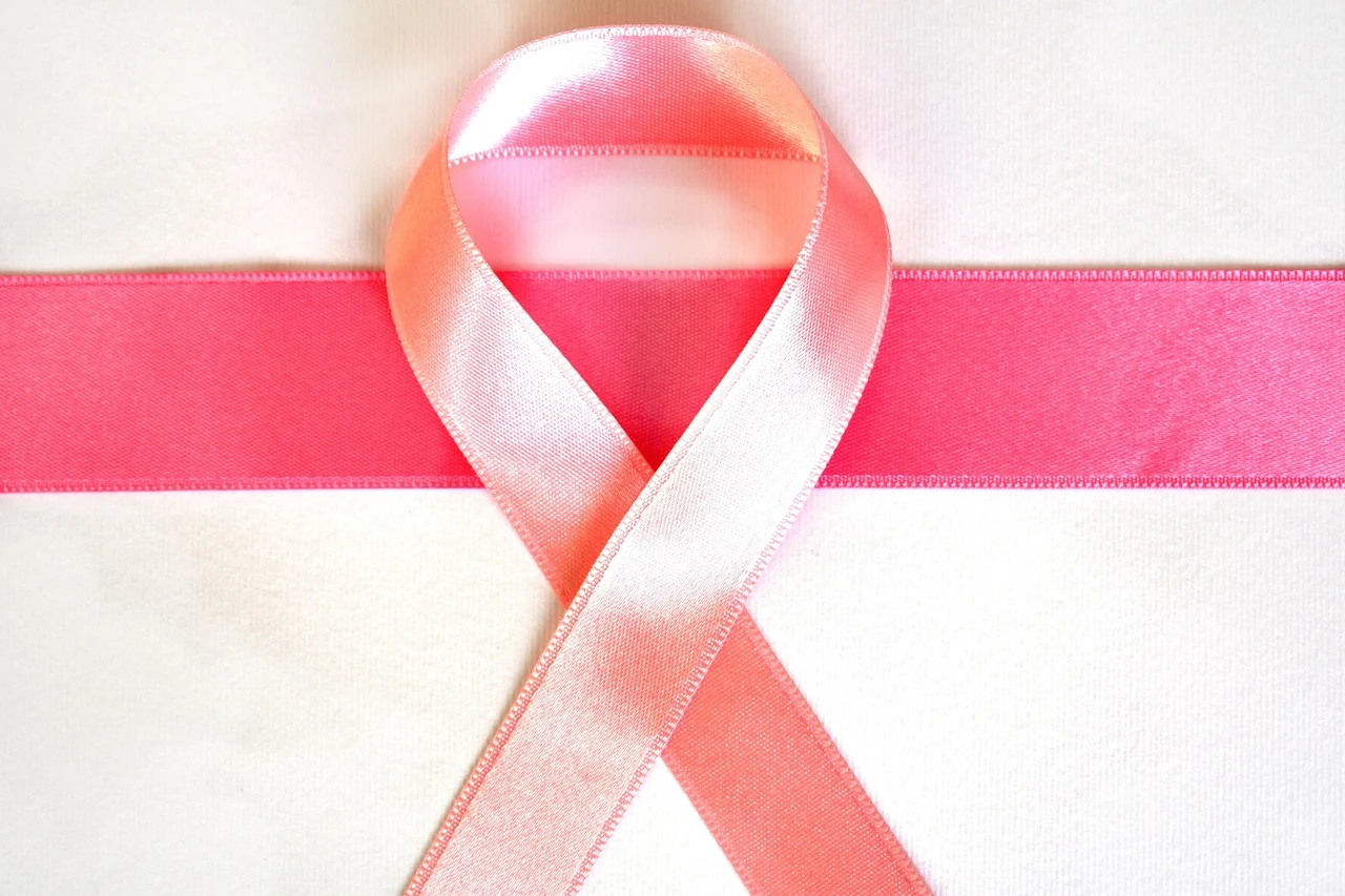 Pink ribbon on a light background, a symbol of cancer awareness and support for patients in oncology
